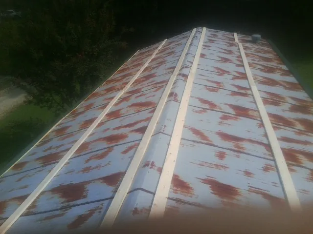 Rusted metal roof panels with new wood purlins before replacement — Storm Damage Roof Repair in Wernersville by Roofing Brothers